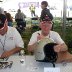 Jack Watson laughs while Fred Harper signs
