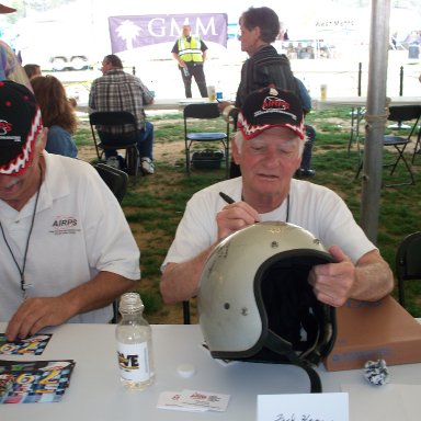 Jack Watson laughs while Fred Harper signs