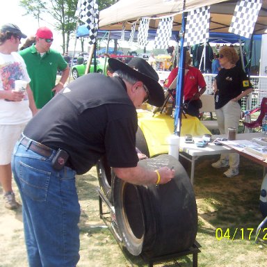Tim signs the tire he blew