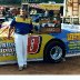 BILLY SCOTT DISPLAYS RACING PHOTO OF GRANDSON 1990S'