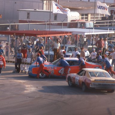 #18 Joe Fasson waits as Petty's crew pushes car back to garage after 1976 Daytona 500