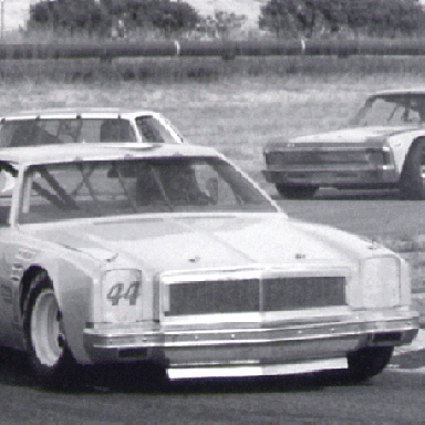 Johnson's #44 leads Insolo and John Borneman at Laguna Seca Raceway.