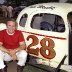 Ken Meahl posed with white coupe in pits 1970