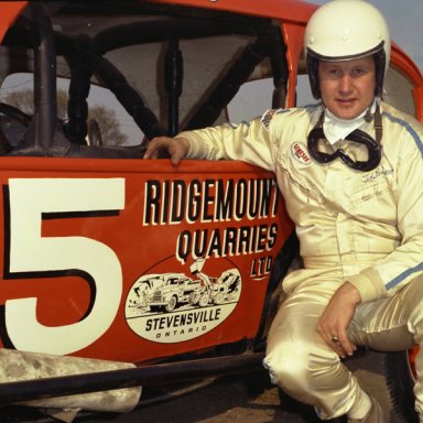 a1 Ted Renshaw posed with orange coach 1970