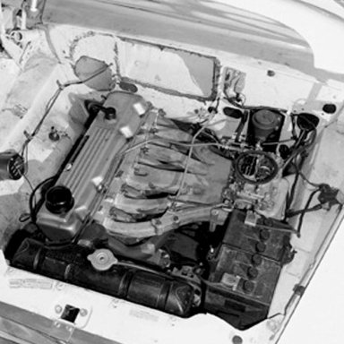 The hot setrup for racing a Valiant in Nascar's compact series - a 4bbl carb on a special tuned manifold for Chrysler's slant 6 motor.