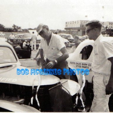 BUCK DUVAL WORKING ON HIS CAR # 44 BOB MCGINNIS DROVE