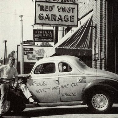 Red Vogt with a Roy Hall car outside his famous Spring Street Shop