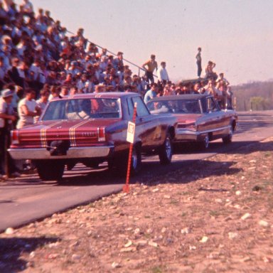 Mr. Norm AWB Dodge being towed down the return lane