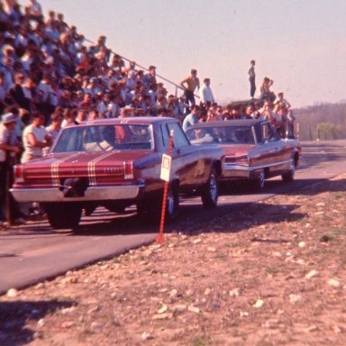 Mr. Norm AWB Dodge being towed down the return lane