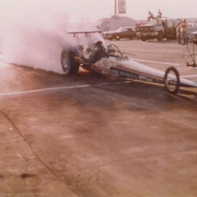 JoAnn Reynolds watches her husband, Mike Reynolds, do a burnout